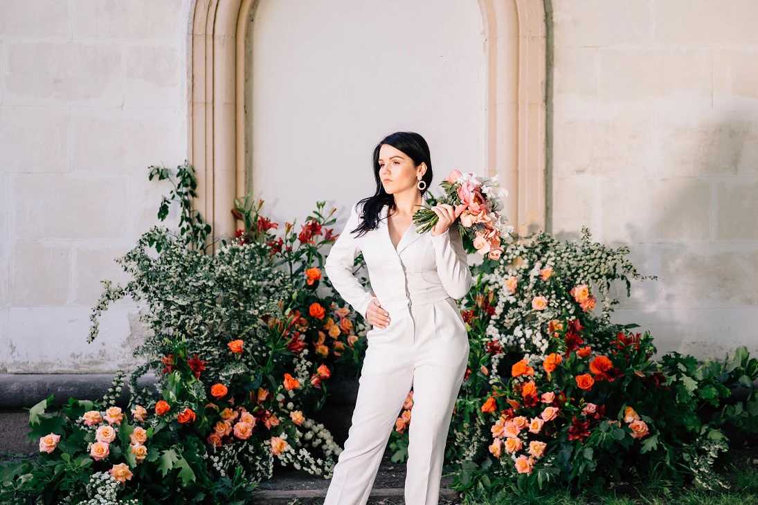 Non-traditional wedding outfit; bride wearing a white wedding suit