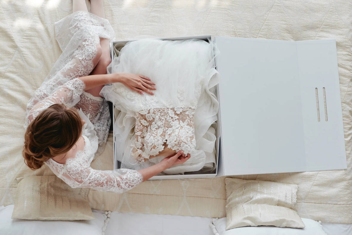 Bride finding the perfect wedding dress inside a box
